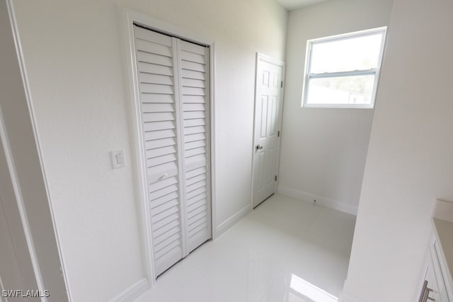 corridor featuring light tile patterned floors