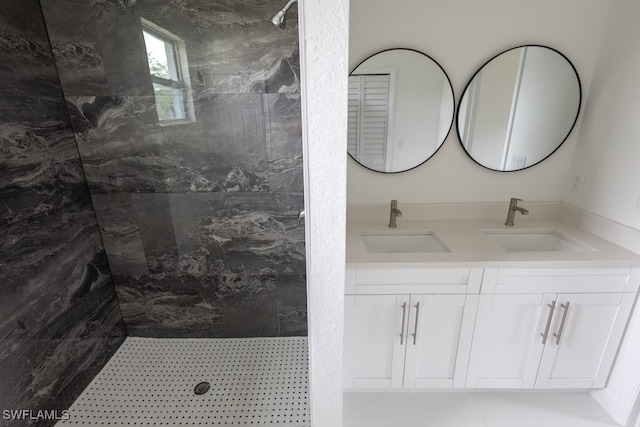 bathroom with vanity and a tile shower