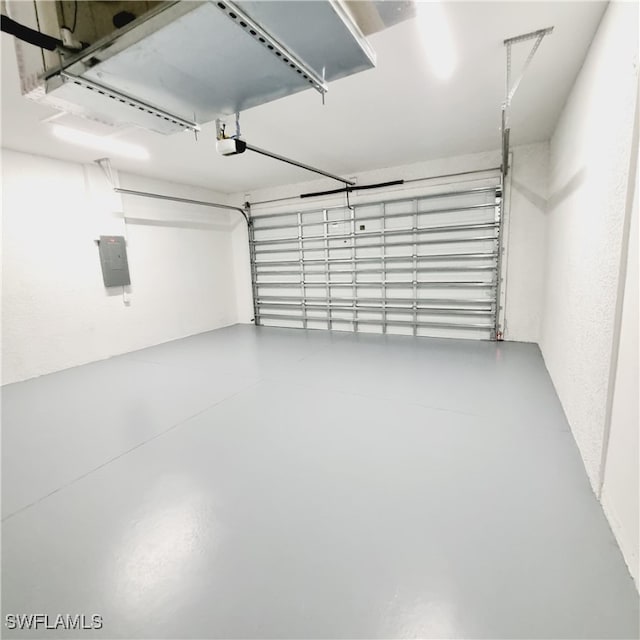 garage with a garage door opener and electric panel