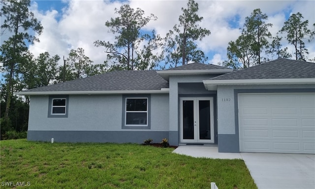 view of front of property with a front yard and a garage