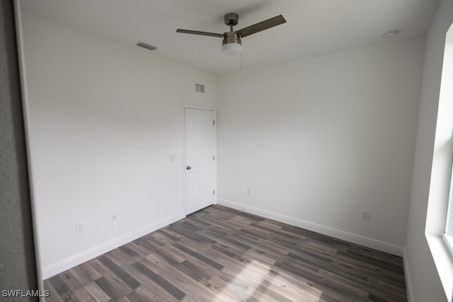 empty room featuring dark hardwood / wood-style floors and ceiling fan