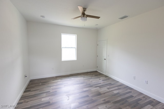 spare room featuring dark hardwood / wood-style floors and ceiling fan