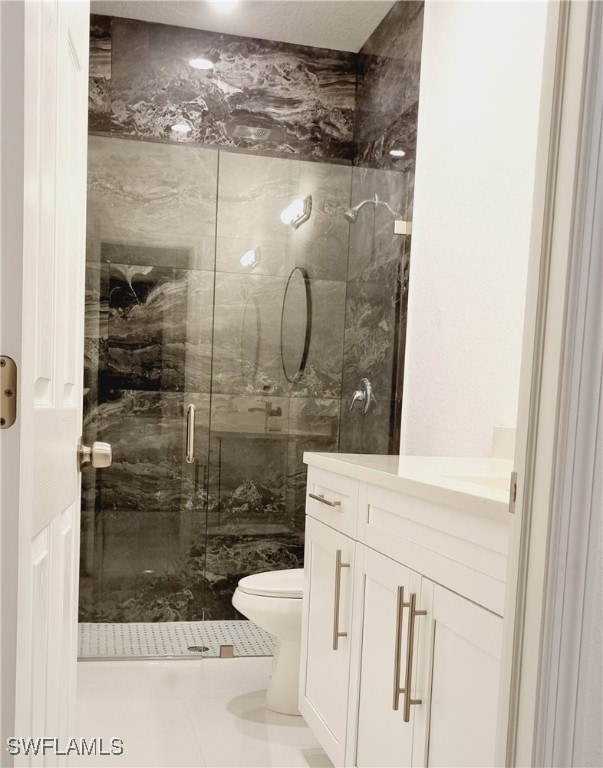 bathroom with vanity, toilet, tile patterned flooring, and a shower with door