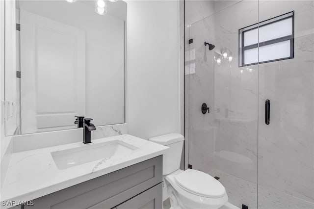 bathroom featuring walk in shower, vanity, and toilet