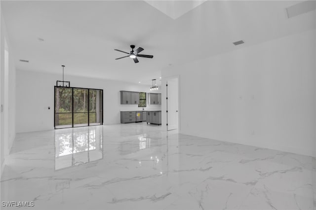 unfurnished living room with ceiling fan