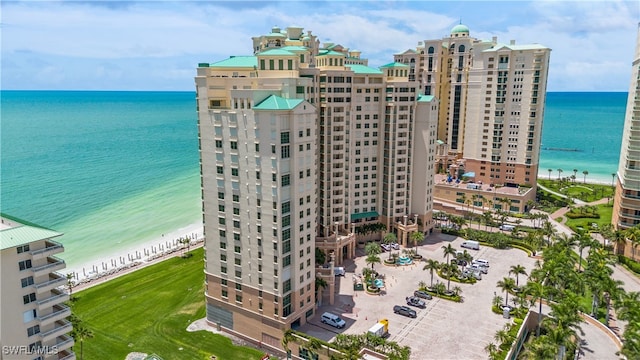 drone / aerial view featuring a view of the beach and a water view