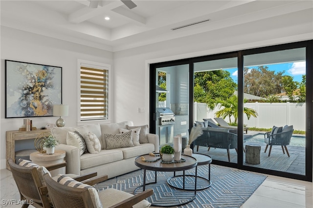 living room with beam ceiling, coffered ceiling, tile patterned floors, and plenty of natural light