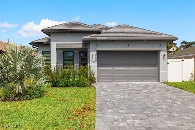 view of front of property with a front yard and a garage