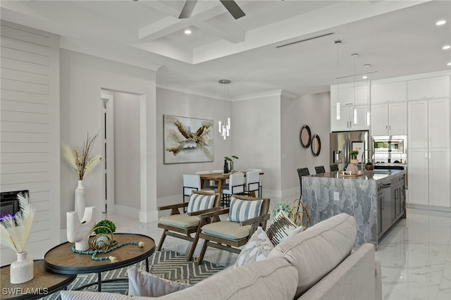 living room with ceiling fan, beamed ceiling, a fireplace, crown molding, and coffered ceiling