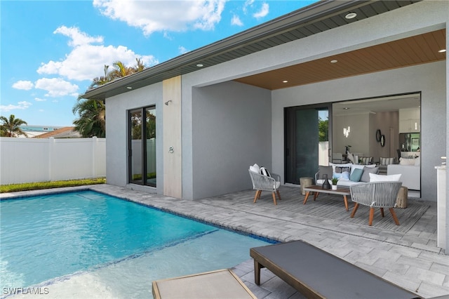 view of swimming pool featuring an outdoor living space and a patio