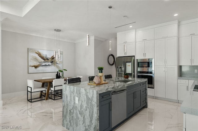 kitchen featuring appliances with stainless steel finishes, decorative light fixtures, and white cabinets