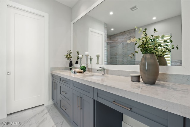 bathroom featuring vanity and a shower with door