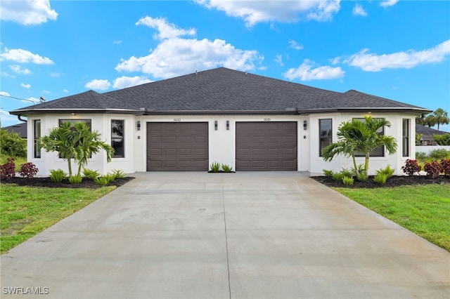 view of front of home with a front yard and a garage