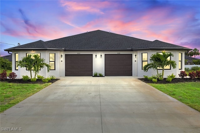 view of front of property featuring a yard and a garage