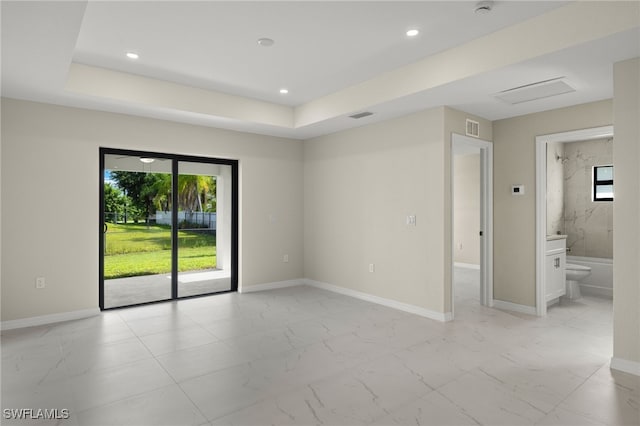 unfurnished room with a raised ceiling