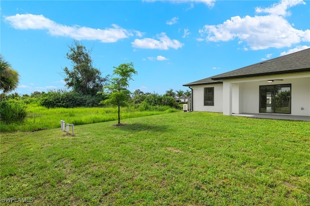 view of yard with a patio area and ceiling fan