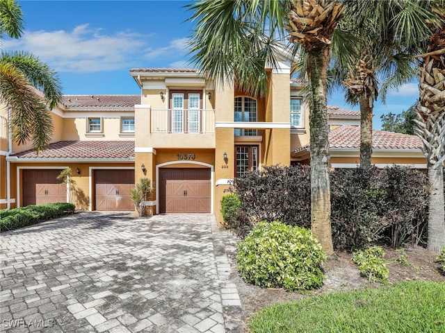 view of front of property with a balcony and a garage