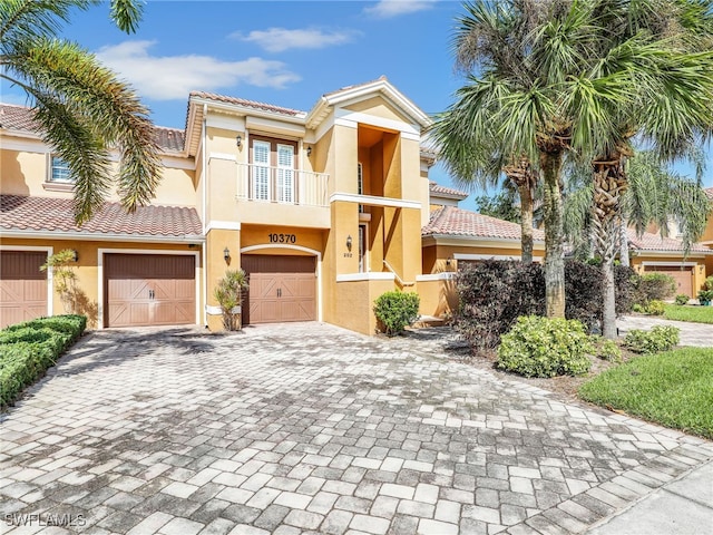 view of front of property featuring a garage and a balcony