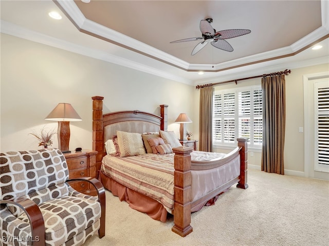 bedroom with ceiling fan, a tray ceiling, crown molding, and carpet