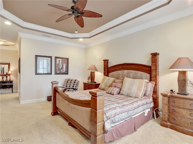 carpeted bedroom with a raised ceiling, crown molding, and ceiling fan