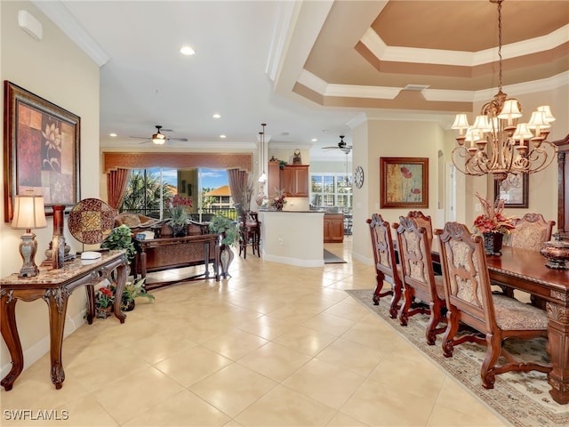 dining area featuring a raised ceiling, ceiling fan with notable chandelier, and crown molding