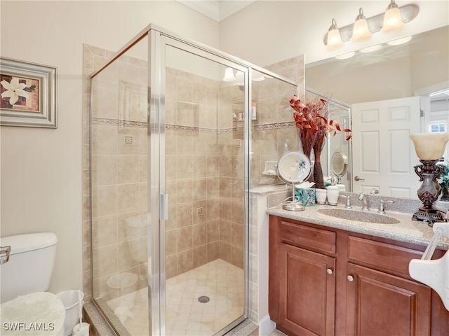 bathroom with walk in shower, vanity, and toilet