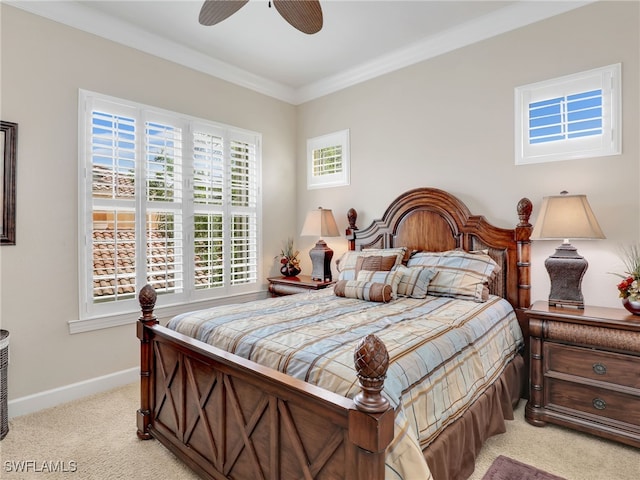 bedroom with ornamental molding, ceiling fan, and light colored carpet