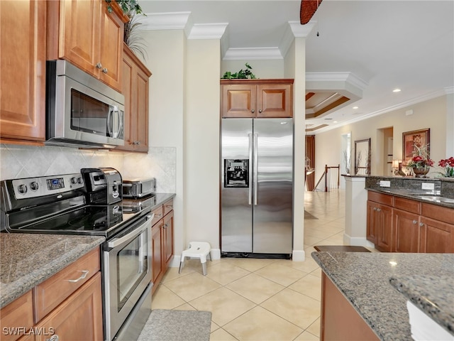 kitchen with appliances with stainless steel finishes, crown molding, and stone countertops