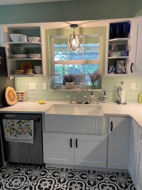 kitchen featuring white cabinetry, hanging light fixtures, light tile patterned floors, and black dishwasher