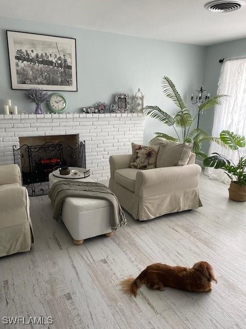 living room featuring hardwood / wood-style floors and a fireplace