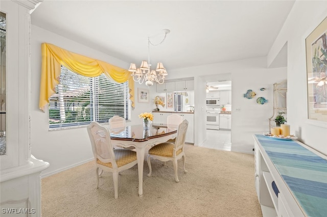 dining area with light colored carpet and an inviting chandelier