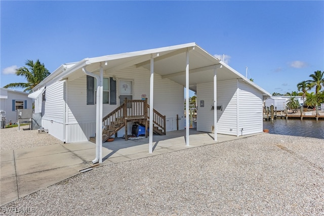 back of property with a water view