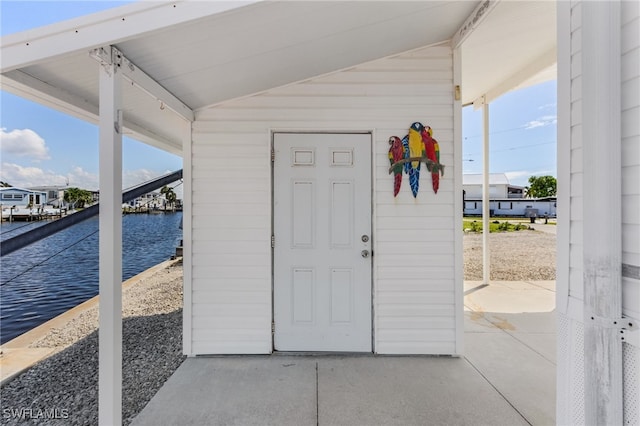 doorway to property with a water view