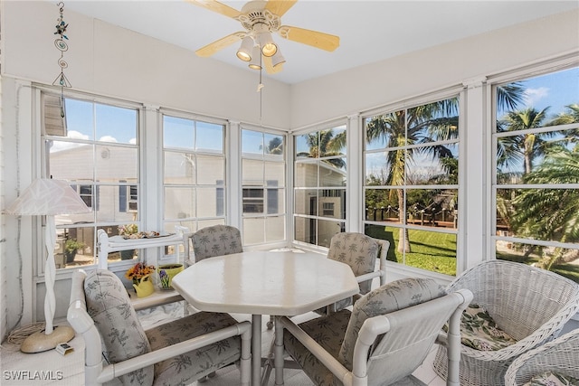 sunroom featuring ceiling fan