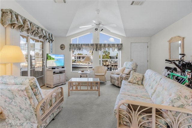 living room featuring light carpet, ceiling fan, and vaulted ceiling