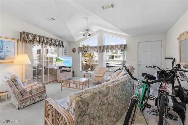 living room featuring light carpet, a healthy amount of sunlight, lofted ceiling, and ceiling fan