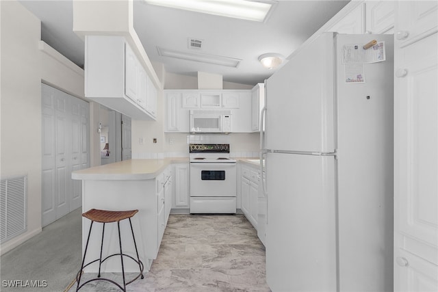 kitchen with kitchen peninsula, white cabinetry, vaulted ceiling, and white appliances