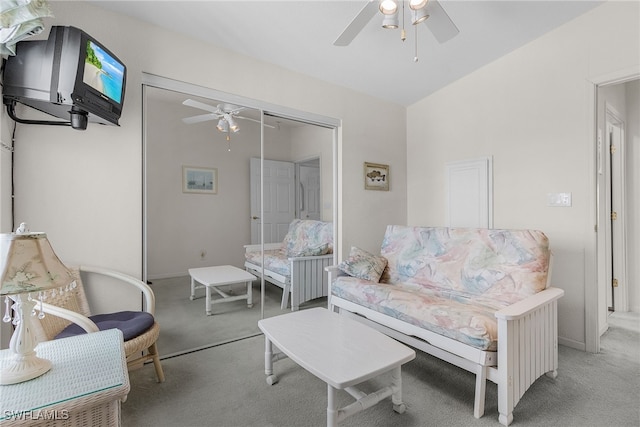 carpeted living room with ceiling fan