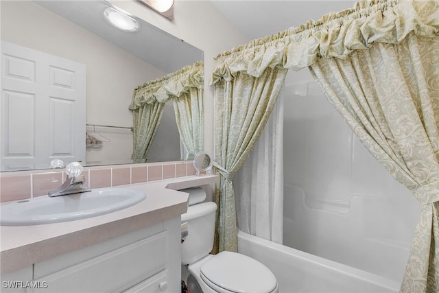 full bathroom featuring toilet, shower / bath combo with shower curtain, and vanity