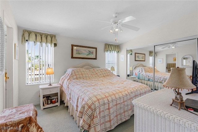 bedroom with vaulted ceiling, carpet flooring, a closet, and ceiling fan