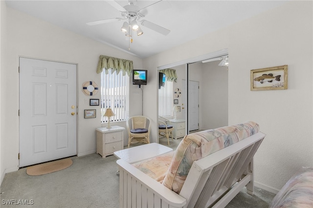 carpeted bedroom with vaulted ceiling, a closet, and ceiling fan