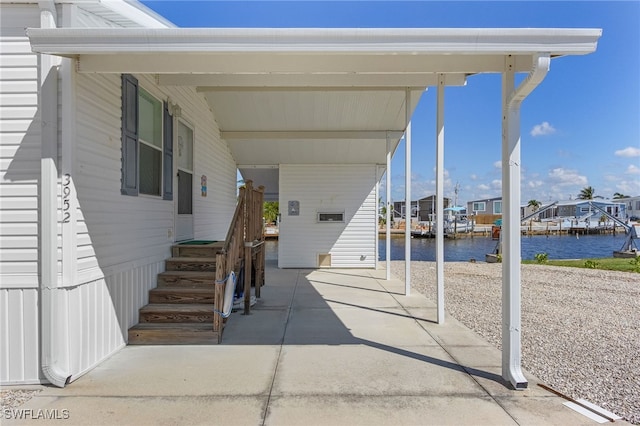 view of patio / terrace with a water view and a boat dock