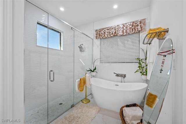 bathroom featuring tile patterned floors and separate shower and tub