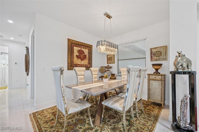 tiled dining room with a chandelier