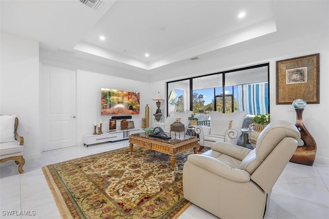 living room featuring a raised ceiling