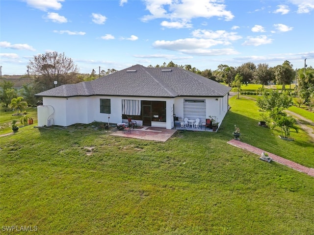 back of property with a yard and a patio area