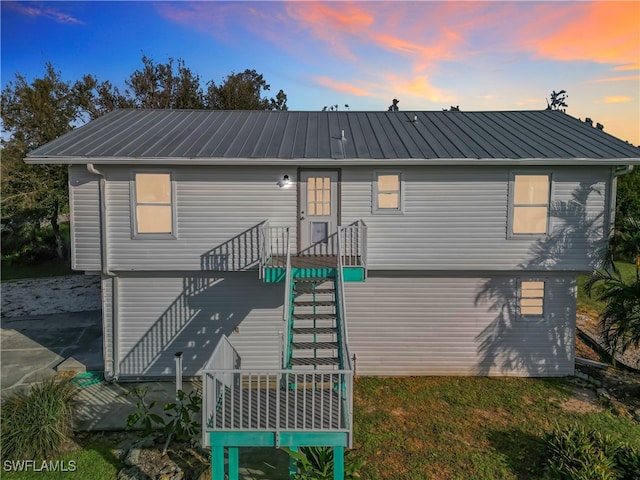 back house at dusk with a deck