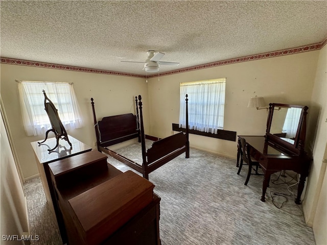 carpeted bedroom featuring a textured ceiling and ceiling fan