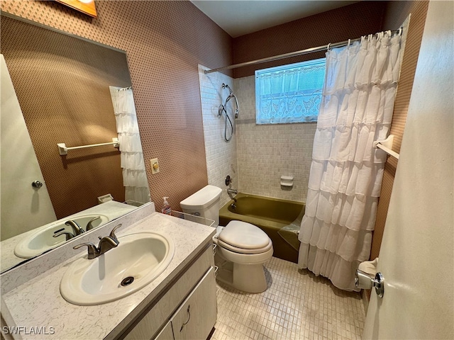 full bathroom featuring toilet, shower / bathtub combination with curtain, and vanity