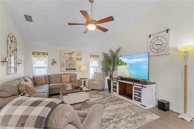 living room featuring light hardwood / wood-style floors and ceiling fan